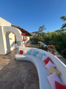 a bench with colorful pillows on a patio at il poggio in Ischia