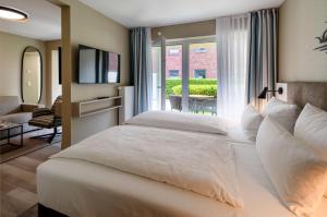 Postel nebo postele na pokoji v ubytování Hotel am Schlosspark garni
