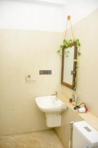 a bathroom with a sink and a mirror at Oshans Home - Guest House - Polhena in Matara +108 photos