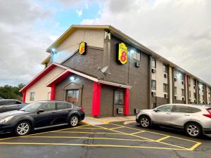 two cars parked in a parking lot in front of a mcdonalds at Super 8 by Wyndham Cedar Rapids in Cedar Rapids