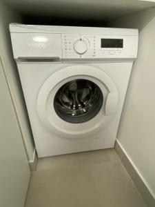 a white washer and dryer in a room at Charmant appartement à Herblay centre, proche gare, 22 min de Paris St Lazare in Herblay