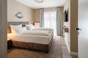 Postel nebo postele na pokoji v ubytování Hotel am Schlosspark garni