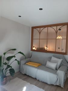 a living room with a couch with a mirror at Casa Loureiro in Redondela