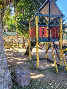 a playground with a slide in a park at Granja Brasil puc 10 2 in Petrópolis