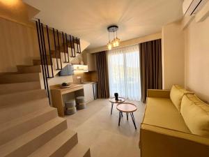 a living room with a couch and a table at GeoMar Luxury Apartments in Skala Marion