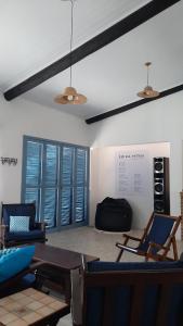 a living room with chairs and a table at CasaMar: confortável e decorada, 30km do Chuí in Santa Vitória do Palmar +23 photos