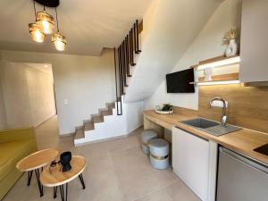 a kitchen with a sink and a counter top at GeoMar Luxury Apartments in Skala Marion