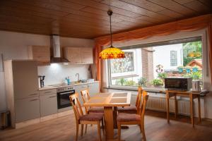 una cucina con tavolo, sedie e finestra di Gasthaus zum Odenwald a Schannenbach
