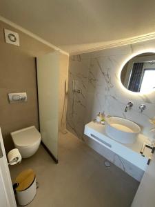 a bathroom with a sink and a toilet at GeoMar Luxury Apartments in Skala Marion