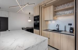 a kitchen with a large white marble counter top at Beautiful Apartment In Novi Vinodolski in Novi Vinodolski