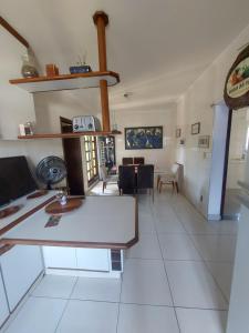 a living room with a table and a dining room at CASA AMPLA e COMFORTAVEL in Campinas