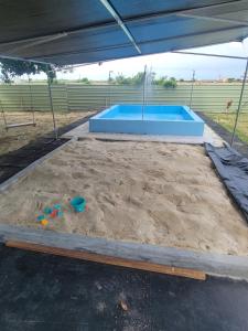 a sandpit with a sandbox and a swimming pool at 龍園民宿二館 in Budai