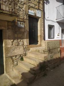 a stone building with stairs leading to a door at LOS ORIZOS Sierra de Gata Extremadura TR-CC-00392 in Villamiel