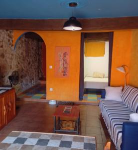 a living room with a couch and a table at LOS ORIZOS Sierra de Gata Extremadura TR-CC-00392 in Villamiel