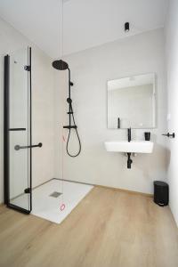a bathroom with a shower and a sink and a mirror at GALIHOST - Apartamentos Vento Mareiro in Sanxenxo