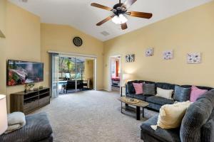 a living room with a couch and a flat screen tv at Davenport lake view private villa in Davenport