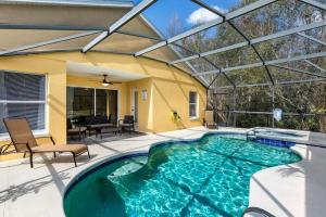 an indoor swimming pool with a patio and a house at Davenport lake view private villa in Davenport