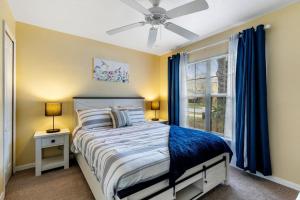 a bedroom with a bed and a window with blue curtains at Davenport lake view private villa in Davenport +24 photos