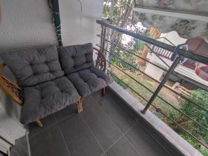 a chair sitting on a balcony next to a window at 2 bedroom apartment for 4 people 42m from the sea in Perea