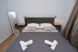 a bedroom with a bed with two white socks on it at Luxury apartments Nicole in Trogir