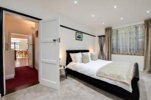 a bedroom with a bed and a large window at Wildflower Garden in Portsmouth