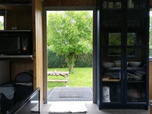 an open kitchen door with a view of a park at Le Beau Rivage - M24 in Trois-Ponts