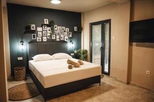 a bedroom with a large bed and pictures on the wall at Zen Apartments in Strumica