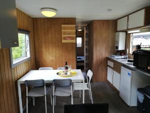 a kitchen and dining room with a table and chairs at Le Beau Rivage - M24 in Trois-Ponts