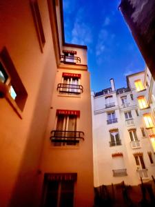 a tall building with balconies on the side of it at Luxor Bastille Hotel in Paris