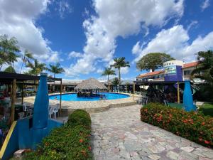 a pool at a resort with people in it at Hotel Riviera D Amazonia Belem Ananindeua in Belém +46 photos