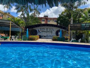 a swimming pool in front of a hotel at Hotel Riviera D Amazonia Belem Ananindeua in Belém