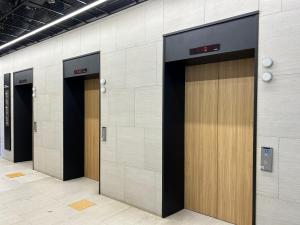 a row of elevator doors in a building at Sungsan Marina Hotel in Seogwipo