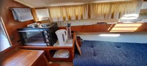 a small kitchen in an rv with a microwave at Unique boat 1 in Höganäs