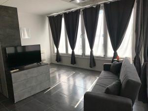 a living room with a couch and a flat screen tv at Lake Garda Lovers Luxury in Peschiera del Garda