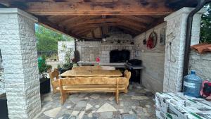 a stone patio with a table and a stove at Apartmani Nada in Pula