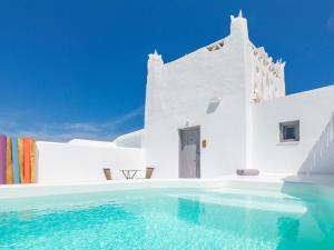 a swimming pool in front of a white building at Axel Beach Mykonos - Adults Only in Mýkonos City