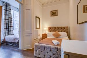 Postel nebo postele na pokoji v ubytování Streathem Hotel