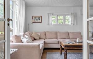 a living room with a couch and a table at Holiday Home Bjørnsknudevej Juelsminde Iii in Juelsminde