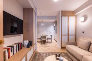 a living room with a couch and a table at Quartier Libre Opera in Paris