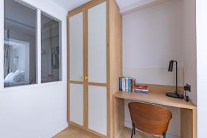 a room with a wooden desk and a chair at Quartier Libre Opera in Paris