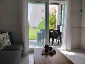 a living room with a teddy bear sitting on a table at Appartement au bord de la mer in Saidia 