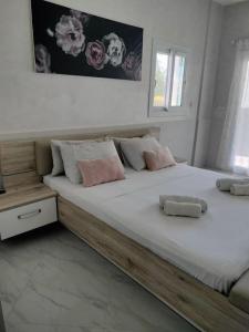 a large bed with two pillows on it in a bedroom at Appartement au bord de la mer in Saidia 