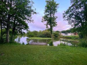 a park bench sitting in the middle of a pond at Cornwall caravan in Crantock