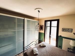 a bedroom with a bed and a glass wall at Casa dello Chef, Il loft nel cuore della città in Lecce