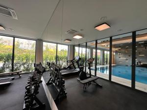 a gym with a pool and a lot of exercise equipment at Anchoria Holiday SPA in Mechelinki