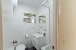 a white bathroom with a sink and a toilet at LAS VEGAS CENTRO- HOME RENt MALAGA in Torre del Mar +12 photos