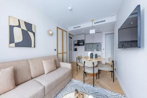 a living room with a couch and a table at Quartier Libre Opera in Paris