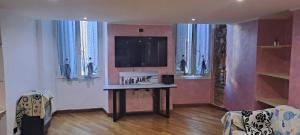 a living room with a table and a tv at World movida in Sanremo