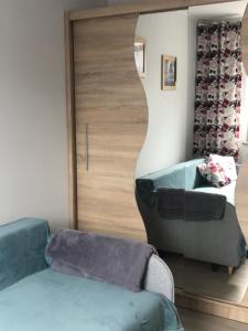 a living room with a couch and a mirror at Kosmos nad morzem in Dziwnówek