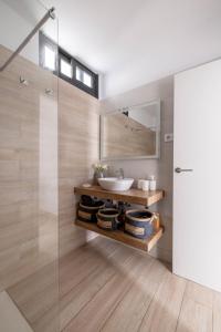 a bathroom with a sink and a mirror at La Palma Luxury in Las Ledas